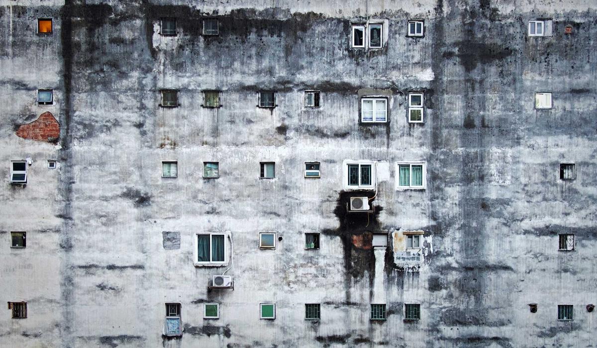 A concrete facade in a regular grid of windows
