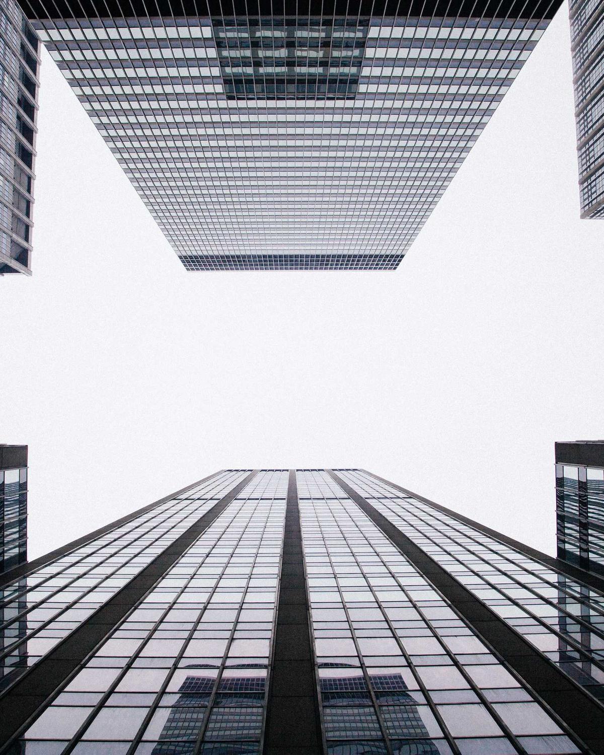 Office towers seen from street level against an open sky